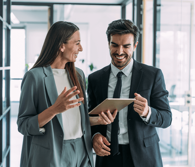 image of a man and woman looking over a tablet in an office