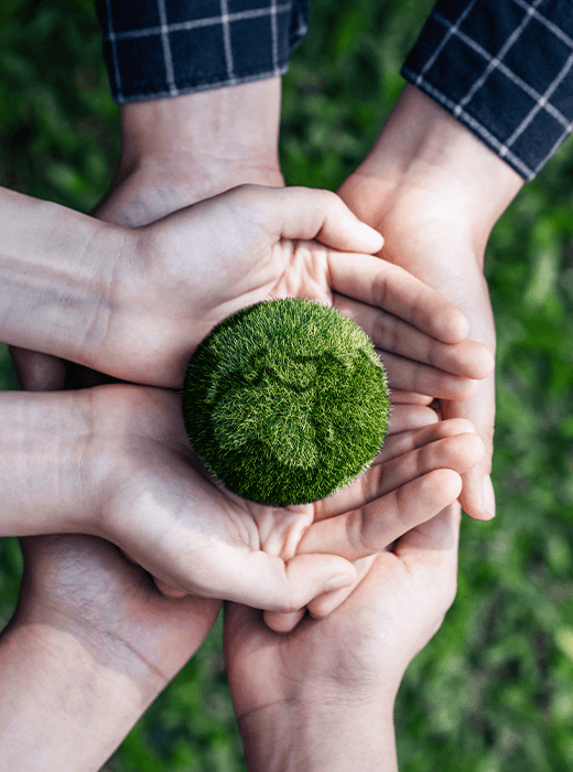 image of hands holding an orb made out of SYNLawn turf that looks like the earth