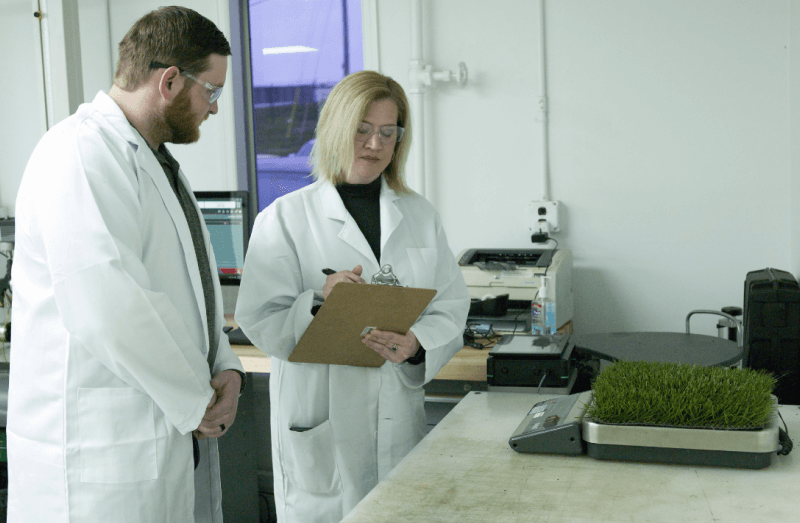 Two scientist in a lab checking the quality of SYNLawn artificial turf