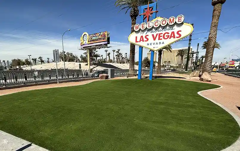 image of SYNLawn artificial turf under the Welcome to Las Vegas sign