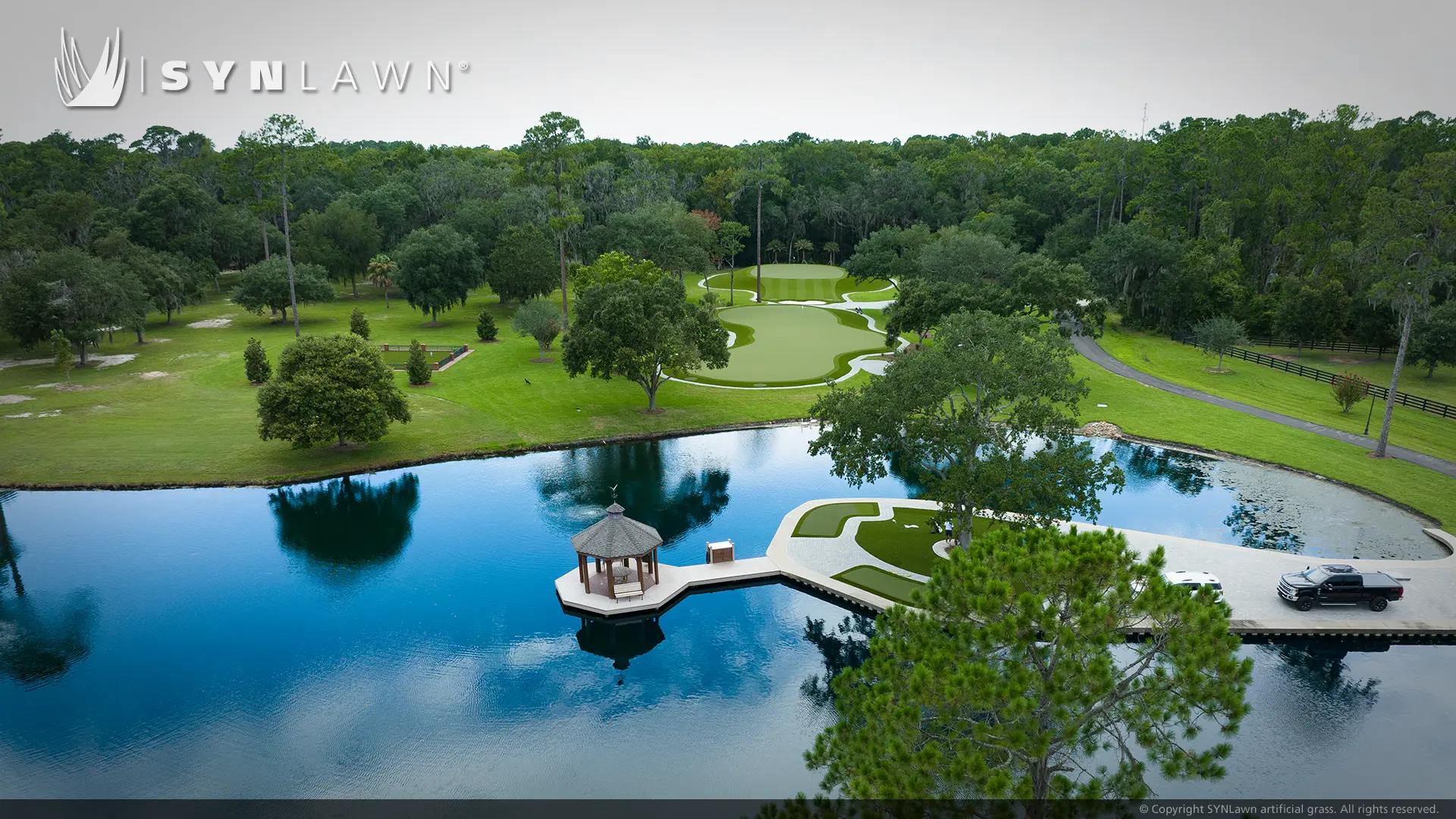 Image from an aerial view of the SYNLawn golf putting green and a body of water