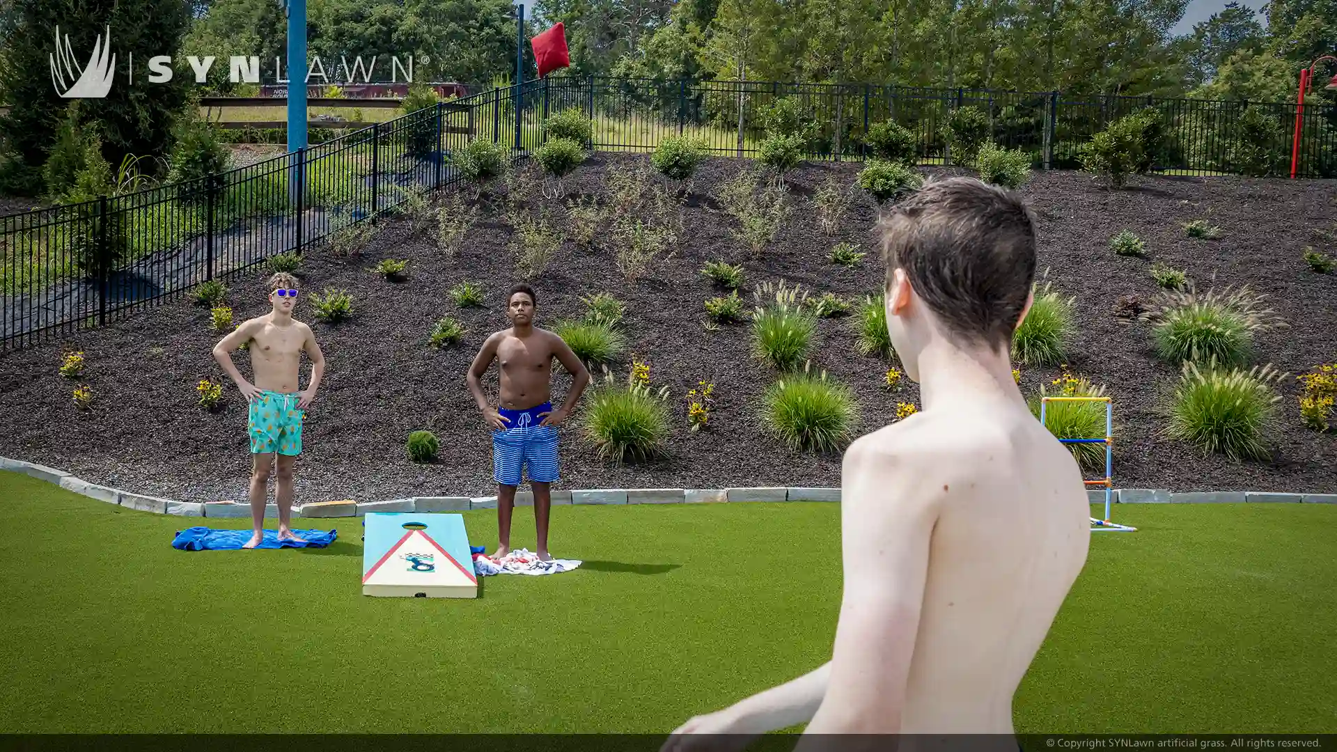 image of children and teenagers playing on artificial grass at victory junction camp water park North Carolina