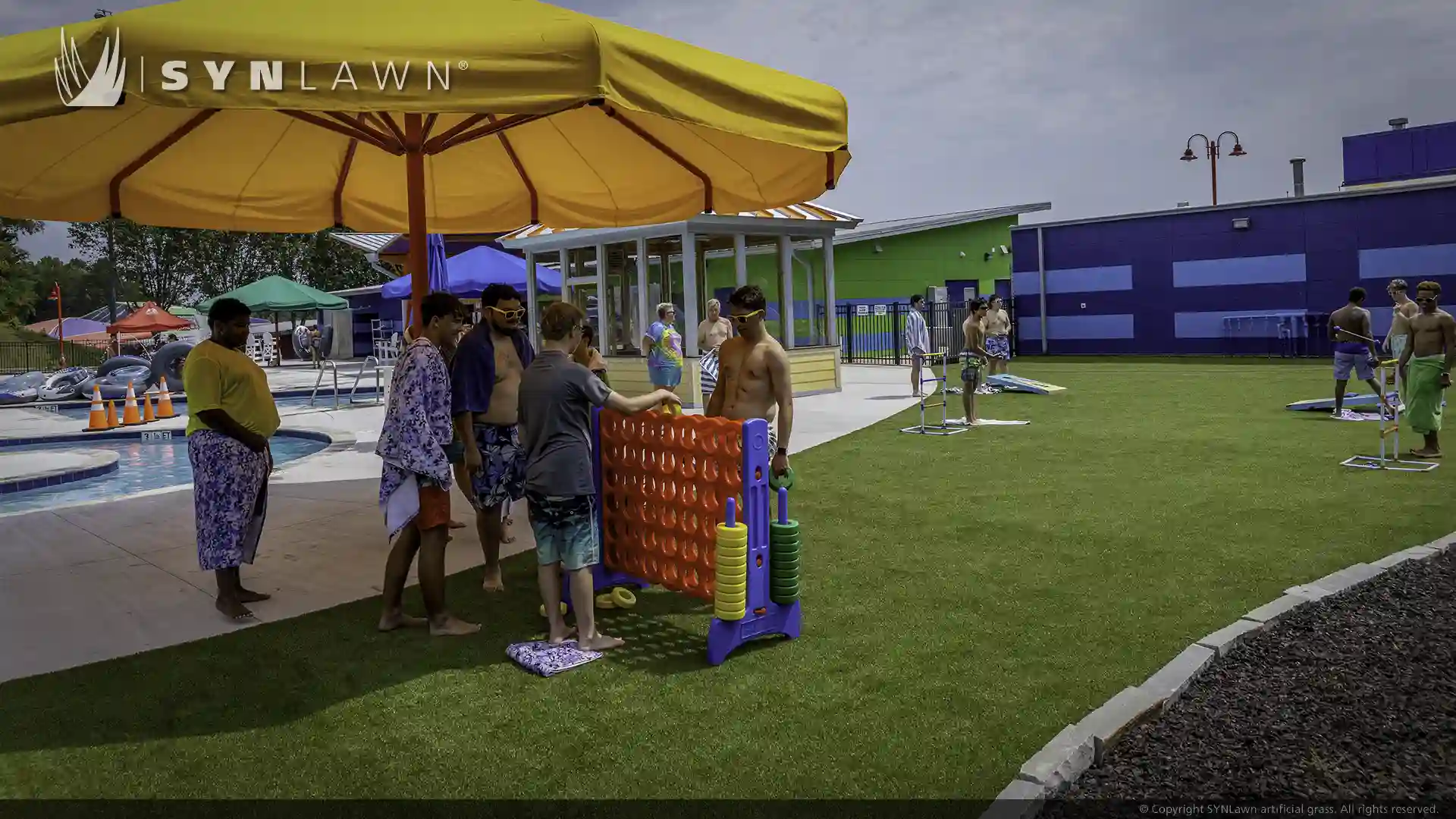 image of children and teenagers playing on artificial grass at victory junction camp water park North Carolina