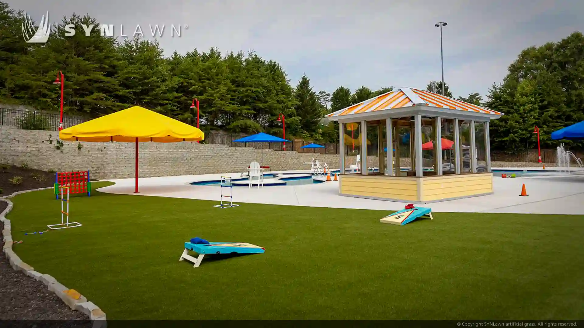 image of children and teenagers playing on artificial grass at victory junction camp water park North Carolina