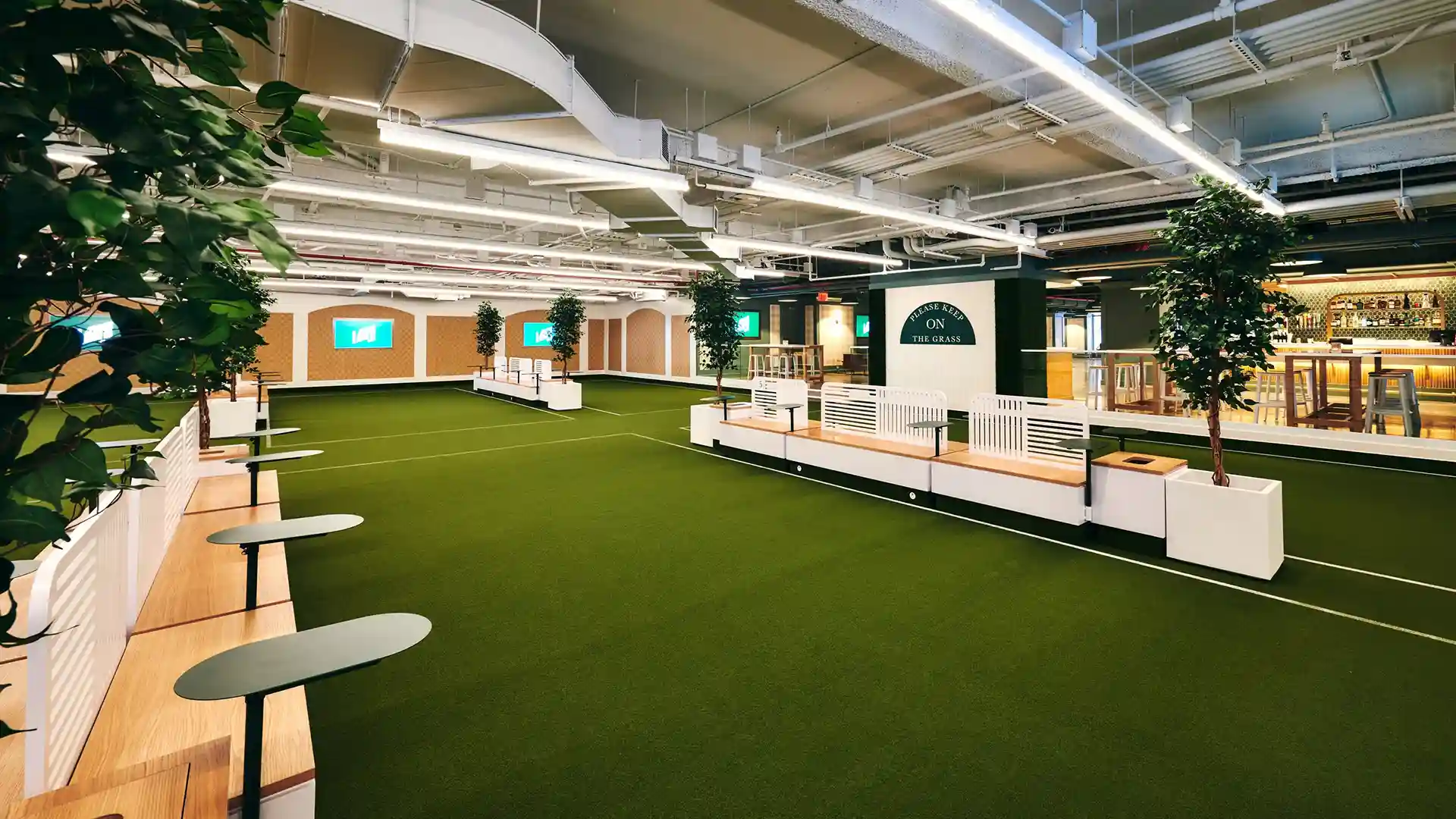 SYNLawn artificial grass at The Lawn Club NYC indoor entertainment complex with outdoor lawn games located in the Seaport District of New York City